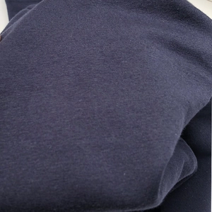Macro shot of dark blue maternity trousers featuring premium fine-knit cotton fabric texture