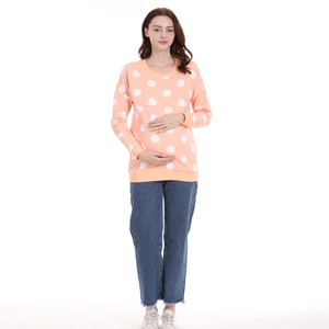 Polka dot nursing sweatshirt in coral pink with denim jeans for postpartum mothers