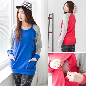 Detail of loose maternity hoodie featuring color block sleeves and nursing snap buttons