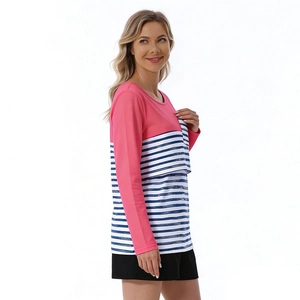 Detail view of the breastfeeding layer and blue white striped patchwork on a pink nursing top