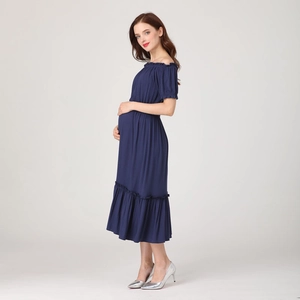 Detail of dark blue maternity dress with off-shoulder neckline and ruffle hem details