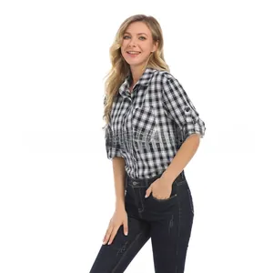 Detail of checkered maternity shirt featuring roll-up sleeves and buttoned cuffs
