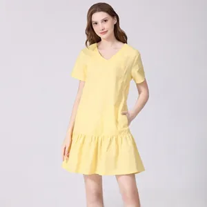Detail of yellow V-neck maternity dress with ruffles and invisible side pockets