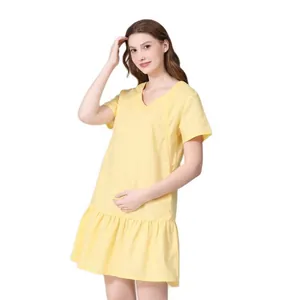 Detail view of yellow V-neck maternity dress with ruffled hem and nursing opening