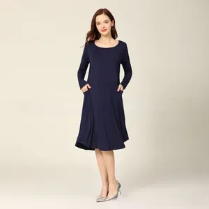 Detail of navy blue long sleeve maternity dress showing side pockets and soft cotton fabric