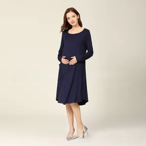 Detailed view of long sleeve maternity nursing dress with hidden side pockets in navy blue