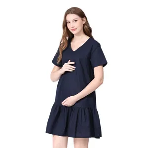 Detail of navy blue V-neck maternity dress with ruffled hem and nursing access design