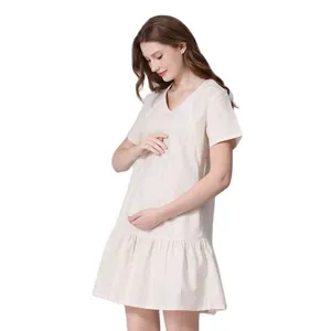 Detail of V-neck maternity dress in breathable cotton linen with ruffled hem design