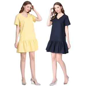 Detail of short sleeves and v-neck design on maternity dress with ruffle hemline