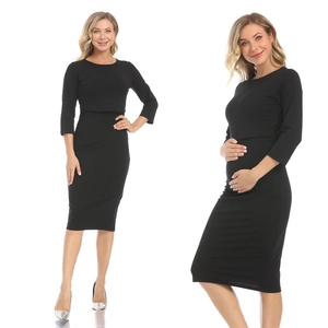 Slim fit black maternity dress featuring a crew neck and three-quarter sleeves