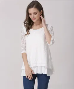 Detailed view of white floral lace texture and lightweight chiffon layers on the blouse
