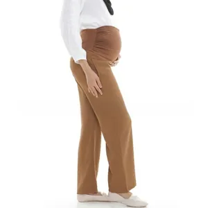 Detail of high waist maternity trousers in dark coffee with elastic belly support band