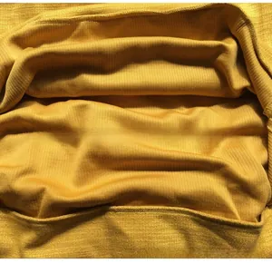 Détail du tissu en maille côtelée jaune montrant la texture douce et les rayures verticales