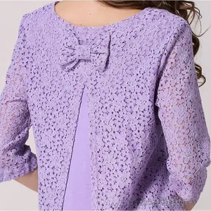 Close-up of lilac floral lace texture with a decorative bow on the back of the maternity top