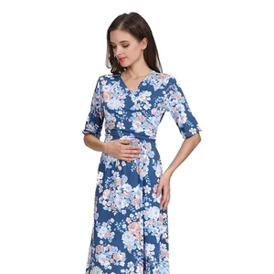 Detail of V-neck maternity dress with navy blue floral print and wrap design texture