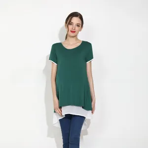 Detail of dark green maternity T-shirt with layered white chiffon hem and round neck