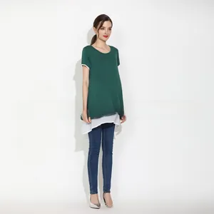 Detail of layered maternity nursing top with green knit and white chiffon hem in studio