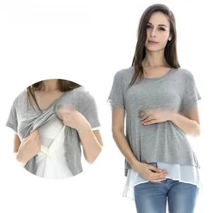 Detail of grey maternity nursing top featuring layered design and white hem splicing