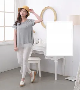 Detail of loose maternity gray t-shirt with fake two-piece white layered hem for nursing