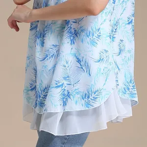 Detail of tropical palm leaf print maternity top featuring a layered chiffon hemline