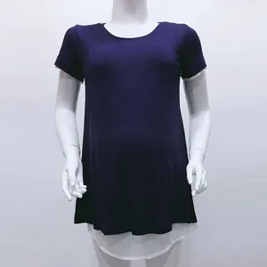 Detail of loose maternity nursing top featuring a navy faux-layered hem design