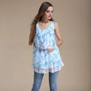 Detail of loose chiffon maternity top with blue palm leaf pattern and white hem