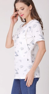 Detail of white cotton nursing top with light blue sailboat prints and layered breastfeeding design