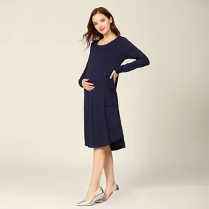 Detail of dark blue maternity nursing dress with long sleeves and functional side pockets