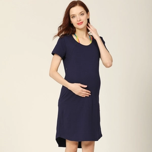 Detail view of navy blue maternity nursing dress with asymmetrical hemline and soft cotton fabric