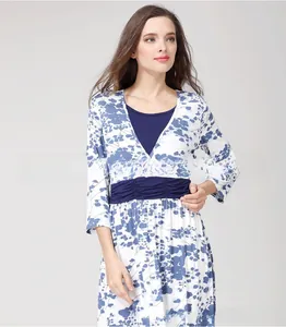 Detail of V-neck floral maternity dress with blue botanical print and high waist line
