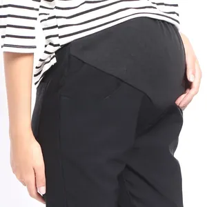 Detail of high waist maternity trousers featuring an elastic belly support waistband