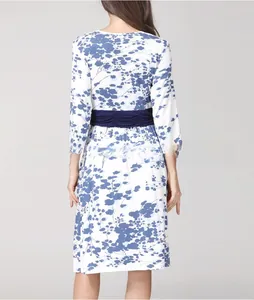 Rear view of floral maternity dress with blue patterns and pleated waist belt detail
