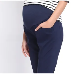 Detail view of high waist maternity pants with elastic belly support for pregnant women