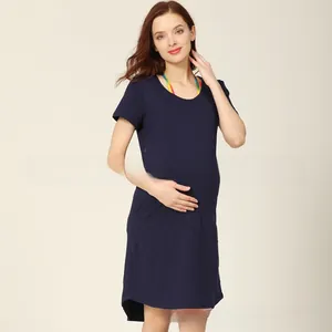 Detail view of navy blue maternity nursing dress with soft cotton fabric and side slit