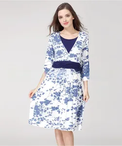 Detail of V-neck floral maternity nursing dress with blue print and pleated waist