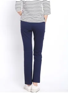 Detail view of the back pocket design on comfortable navy blue maternity pants