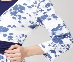 Detailed close-up of V-neck floral nursing dress fabric with navy blue trim and patterns