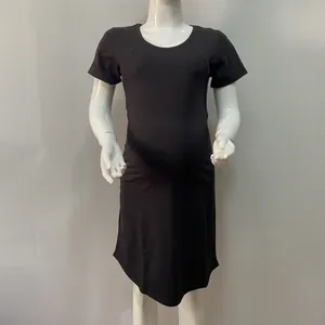 Detail of a black short-sleeved cotton nursing dress featuring a loose A-line silhouette