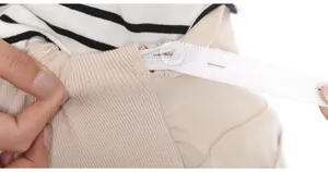 Detail view of adjustable high waist maternity pants with elastic button strap for comfort