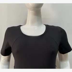 Detail of black maternity nursing dress featuring a slim-fit knit fabric and round neck