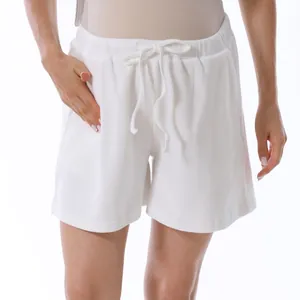Detail of white waffle knit maternity shorts featuring elastic drawstring waistband