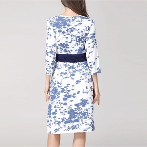Back view of a white floral V-neck maternity midi dress with 3/4 sleeves and blue waist belt