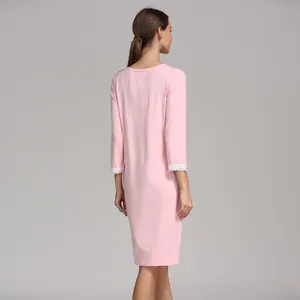 Detailed back view of pink modal maternity dress with white lace trim on the sleeves
