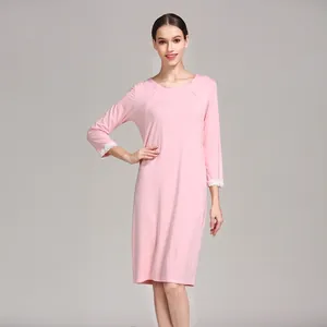 Detail of pink modal nursing dress featuring white lace cuffs and soft knit texture