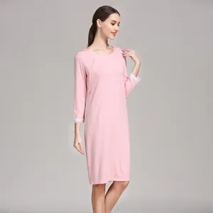 Detail of pink maternity dress featuring soft modal fabric and white lace cuffs
