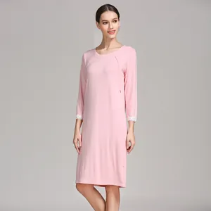 Detailed view of pink modal nursing dress with lace cuffs and vertical breastfeeding access