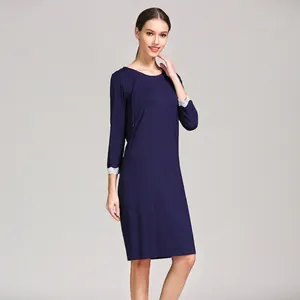 Detail of invisible nursing zipper and white lace cuffs on a navy blue modal dress