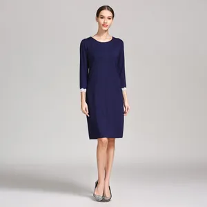 Detailed view of dark blue modal maternity dress featuring white lace cuffs and crew neck