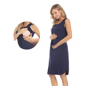 Detail of navy sleeveless maternity dress showing the double-layer breastfeeding opening