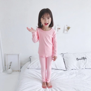 Cozy pink cotton pajamas for kids showing soft ribbed fabric and round neck design